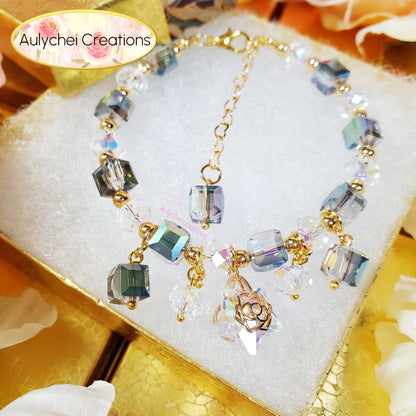Cube crystal bracelet with colorful crystal beads and gold accents on a white and gold surface, featuring 'Aulychei Creations' branding.